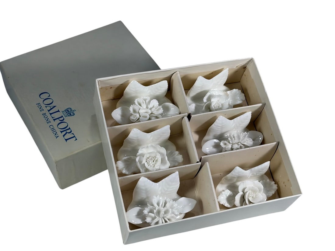 Coalport Bone China Floral Place Card Holders Set: Set of six Coalport fine bone china place card holders, each modeled as a white floral arrangement with detailed sculpted blossoms and leaves. Includes assorted flower forms mounted on shaped bases. P