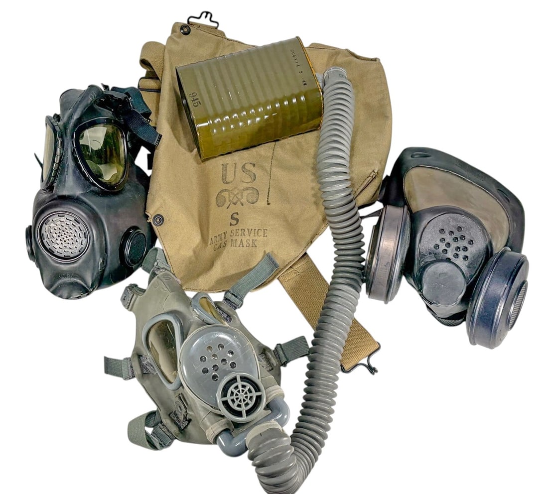 U.S. Army Gas Masks & Respirator Collection: Lot includes two military-style gas masks and associated components. Included is a gray U.S. Army Service Gas Mask with corrugated breathing hose, filter canister, and canvas carrying bag stenciled "U