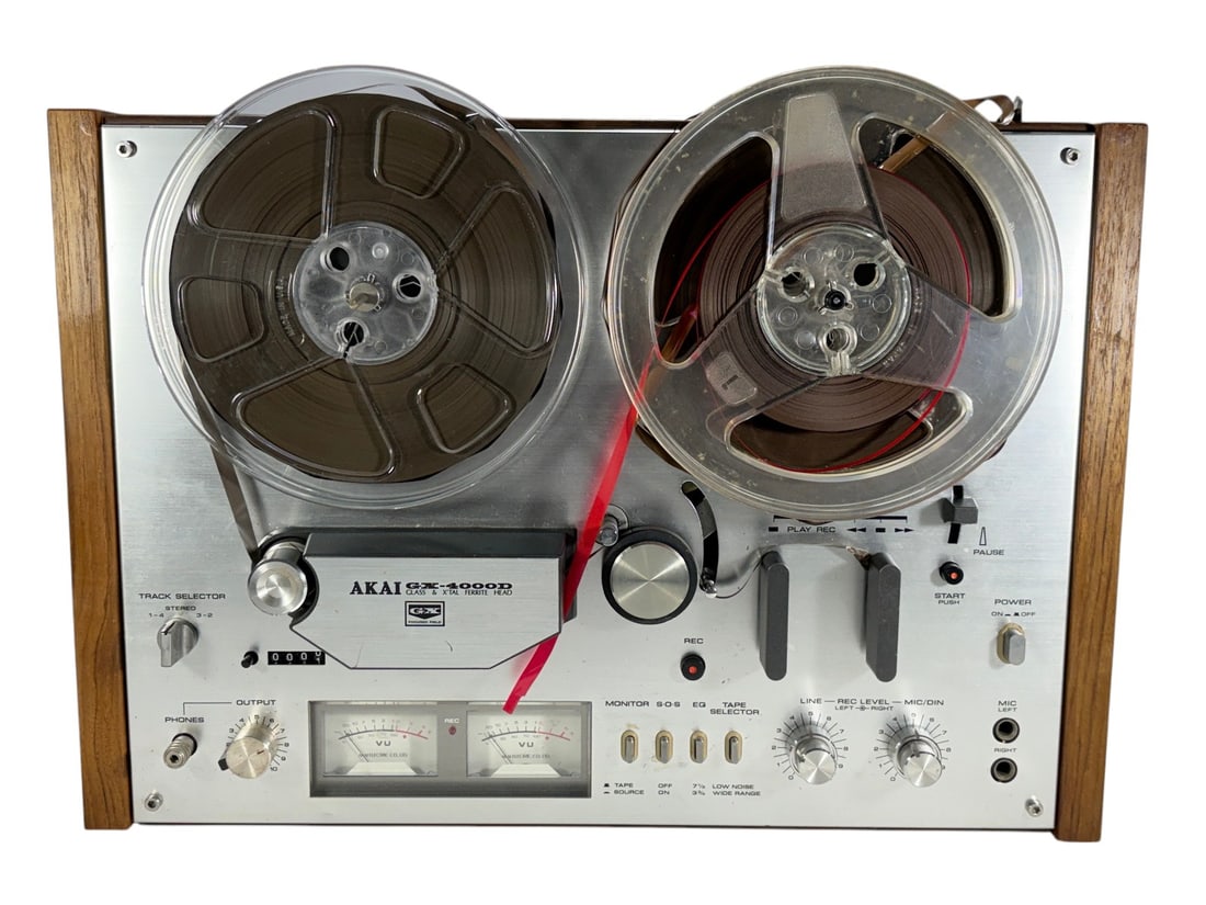 Akai GX-4000D Reel to Reel Tape Deck Made in Japan: Vintage Akai GX-4000D reel-to-reel tape deck manufactured in Japan. Features Akai's renowned Glass & X'tal Ferrite (GX) heads, dual VU meters, wood side cabinet, headphone output, and 33/4 and 71/2 IP