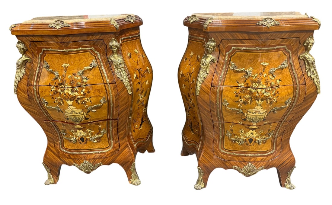 Pair French Marble Top Bombe Nightstands Bronze: Pair of French Louis XV style bombe nightstands, each fitted with three drawers. Constructed with fine wood veneers and intricate marquetry in contrasting exotic woods depicting floral motifs. Each ca