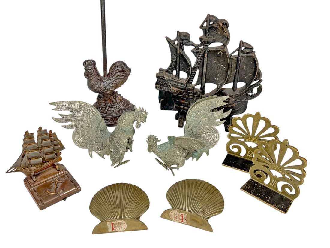 Metal Decorative Accessories & Bookends 9pc LOT: Group of nine decorative accessories and bookends crafted from bronze, brass, iron, and other mixed metals. The lot includes a pair of MTA Boston brass bookends with pierced fan motif, a pair of verdi