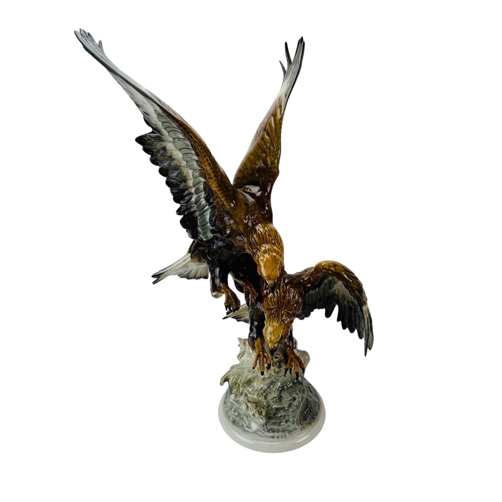 Hutschenreuther Dueling Eagles Porcelain Figurine: Hutschenreuther Germany porcelain bird figural group by Karl Tutter (German, 1883-1969). Depicts two raptors locked in a midair combat, wings outstretched above a rocky outcropping. Executed in natura
