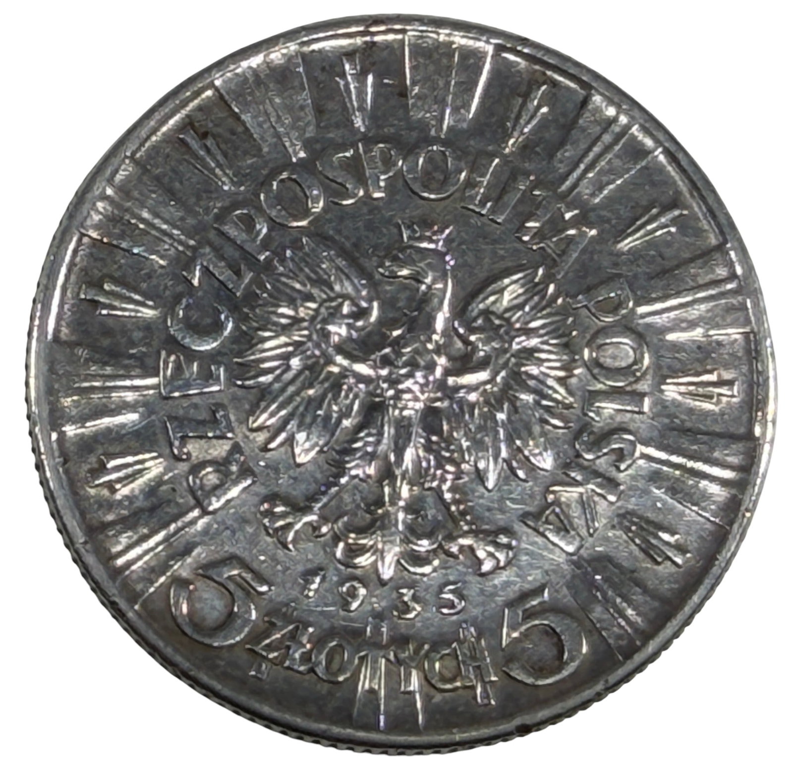 1935 Poland 5 Zlotych Pilsudski Commemorative Coin: 1935 Poland 5 Zlotych silver coin commemorating Marshal Jozef Pilsudski, featuring his left-facing portrait on the obverse and the Polish crowned eagle with radiating design on the reverse. Dated 1935