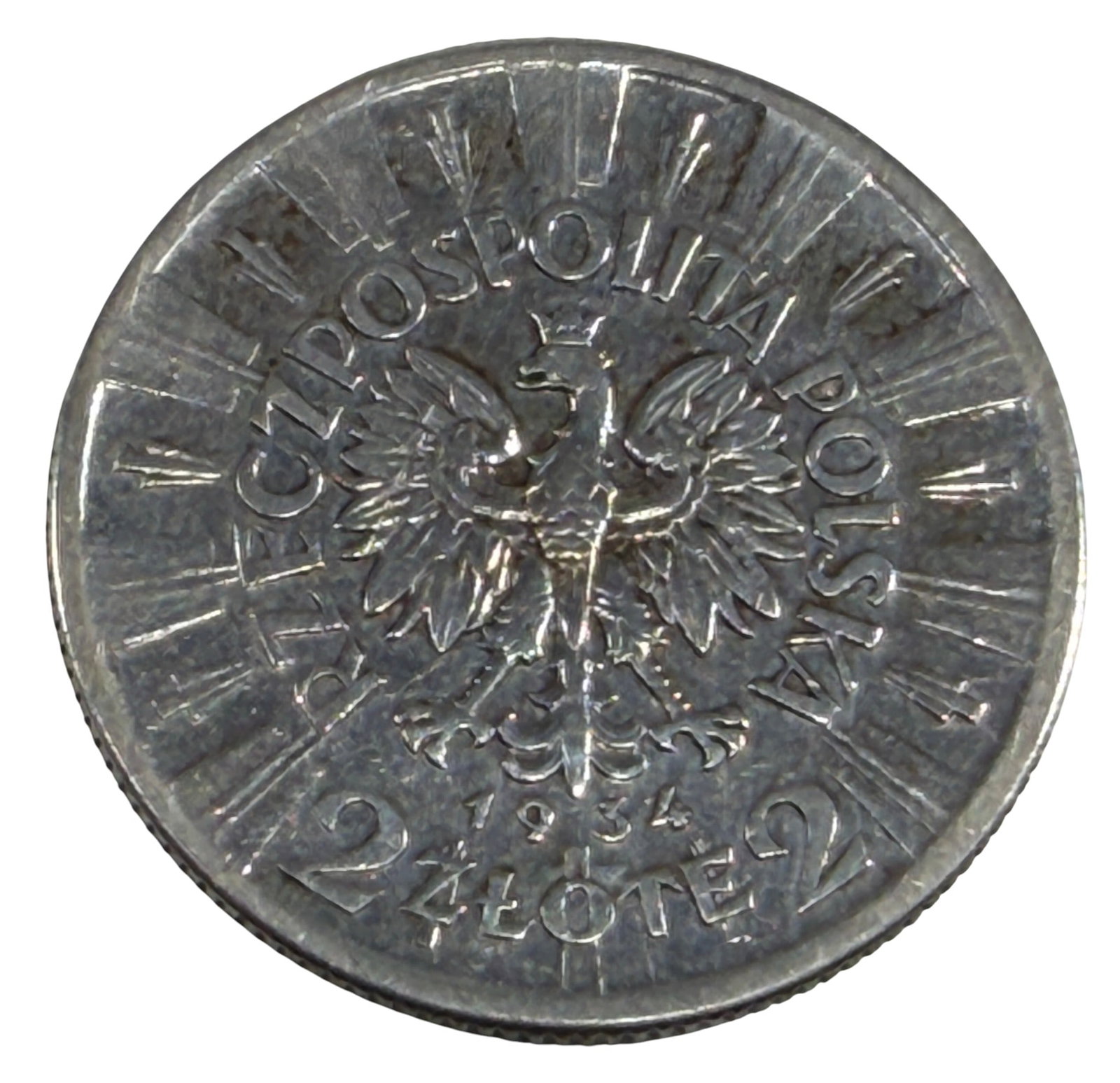 1934 Poland 2 Zlote Jozef Pilsudski Silver Coin: 1934 Poland 2 Zlote silver coin commemorating Marshal Jozef Pilsudski, featuring his left-facing portrait on the obverse and the Polish crowned eagle on the reverse. Dated 1934. Struck in silver. Tota