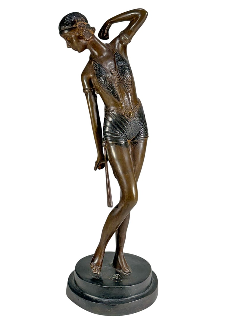Art Deco Style Bronze Lady Figure Sculpture Statue: Bronze figure sculpture depicting a young woman in an elegant Art Deco-inspired pose, standing on a circular base. The figure is shown with one arm raised behind her head and the other at her side, we