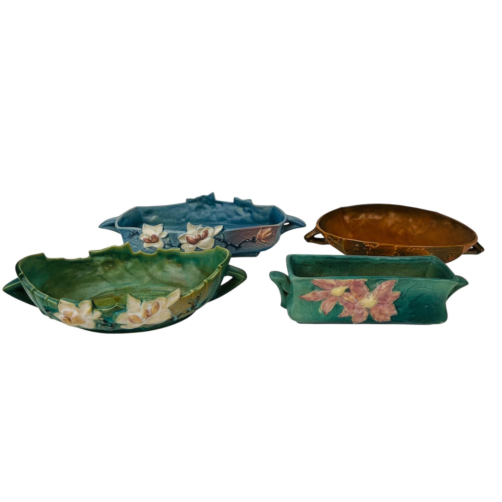 Roseville Magnolia Bushberry Clematis Planters 4pc: Lot of four Roseville American art pottery vessels comprising two Magnolia pattern planters, one in blue glaze, shape 448-10, with applied blossom decoration; the other in green glaze with applied blo
