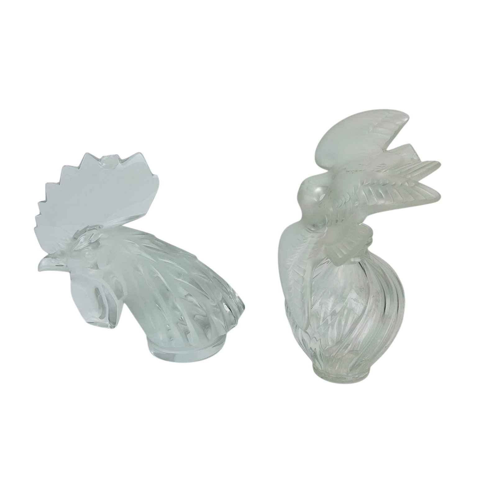 Lalique Tete De Coq Mascot & Nina Ricci Bottle 2pc: Lalique French crystal art glass decorative articles, lot of two. Includes a Tete de Coq (Rooster Head) automobile hood ornament in frosted and clear crystal, signed Lalique France to the base. Accomp