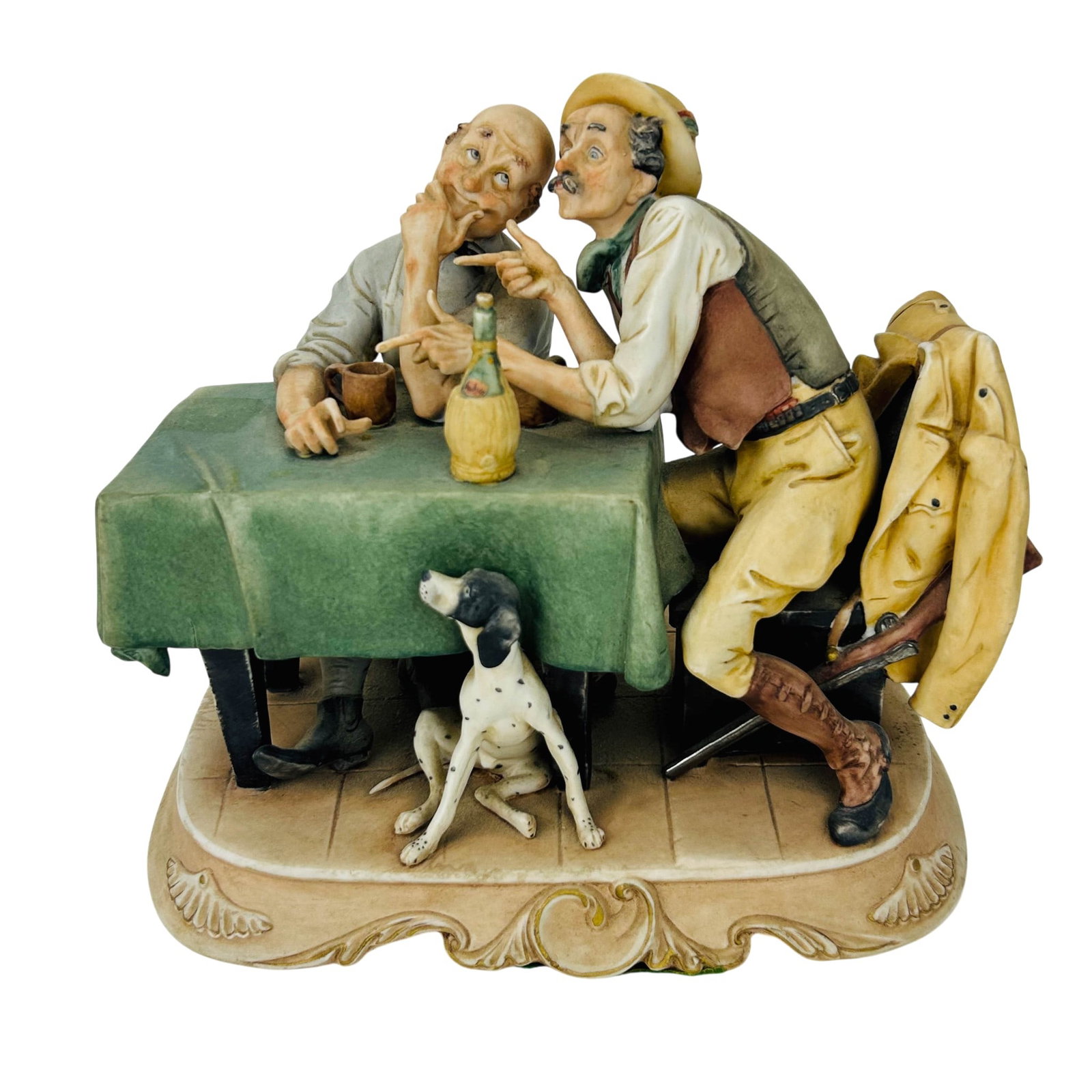 Arnart Hunting Tales Japanese Porcelain Figurine: Arnart Japan porcelain figural group depicting two seated men engaged in conversation at a table draped with a green cloth. The scene includes mugs, a bottle, a seated hunting dog beneath the table, a