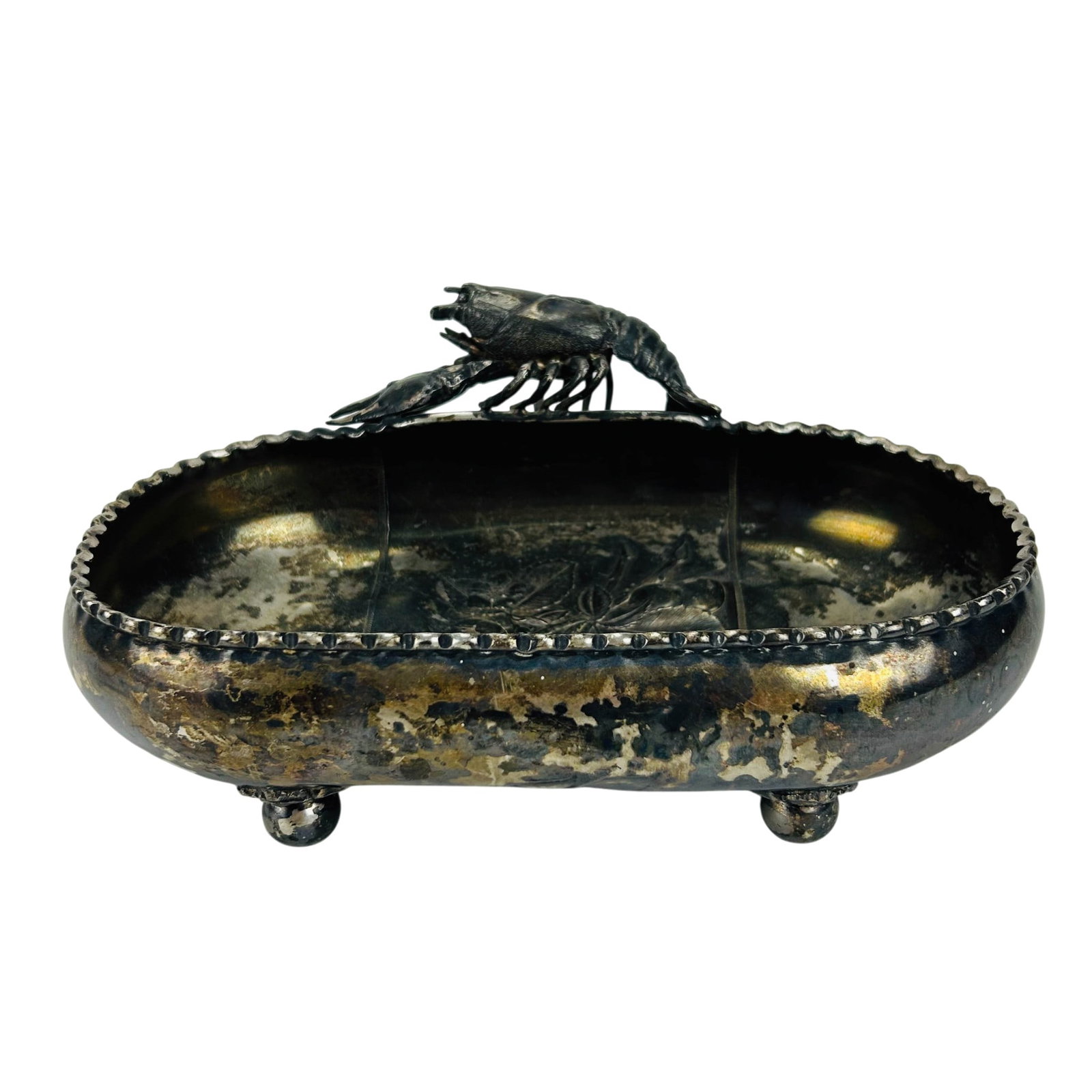 Antique Wilcox Victorian Silverplate Lobster Bowl: Meriden Britannia Company silverplate oval serving bowl featuring a cast lobsetr form handle on the center rim, on one side. Decorated with embossed floral and fruit motifs to the interior and undersi