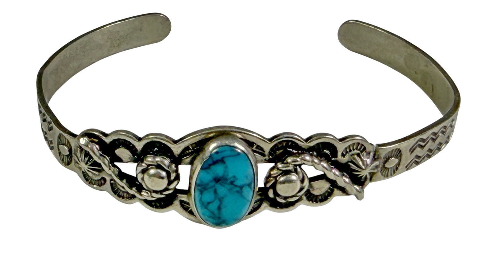 Sterling Turquoise Cabochon Cuff Bracelet 7.2g: Open cuff bracelet featuring an oval turquoise cabochon in a decorative sterling silver setting with stamped floral and geometric accents along the band. Total weight 7.2 grams. Dimensions: 1.5 X 2.5 
