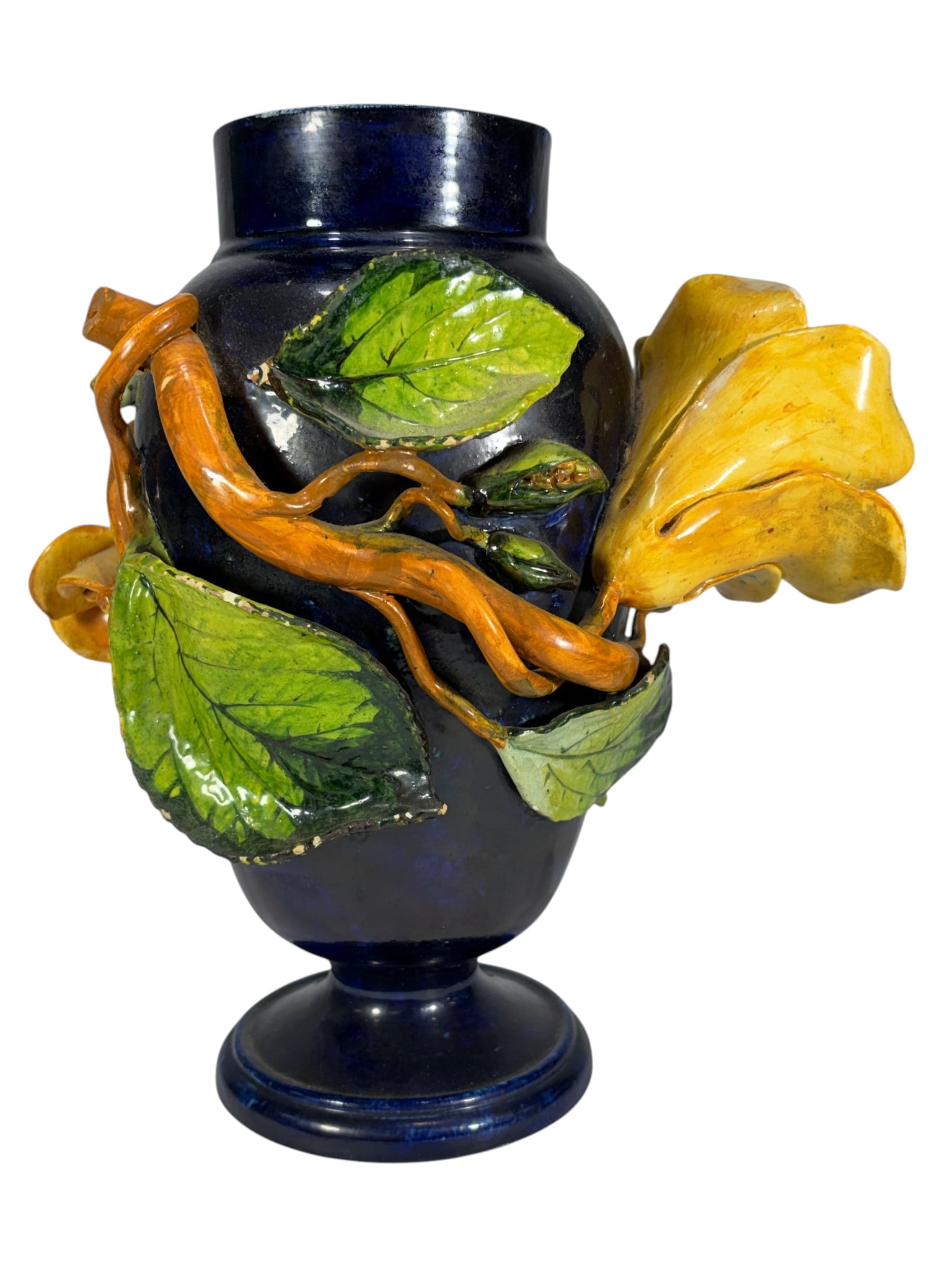 Vintage Majolica Barbotine Floral Pottery Vase: Vintage majolica barbotine pottery vase with a deep cobalt blue glazed body, decorated with applied yellow and pink roses, green leaves, and scrolling vine motifs in high relief. Marked "414 FMC" on t