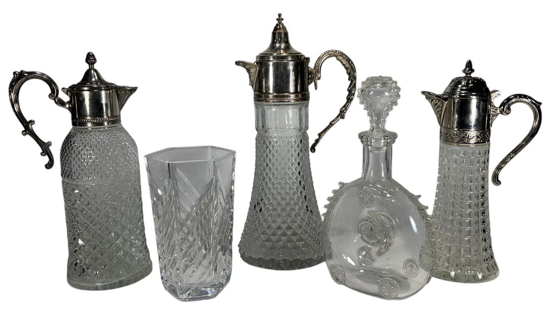 Baccarat France Crystal Decanters & Vase 5pc LOT: Five-piece lot of crystal decorative tableware. Includes one Baccarat Remy Martin Louis XIII crystal decanter with stopper, three crystal claret jugs or decanters with silver-plated mounts, and one cu