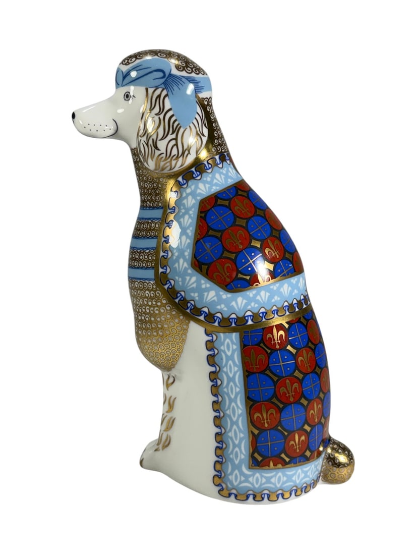 Royal Crown Derby England French Poodle Figure: Royal Crown Derby English bone china figure from the National Dogs series depicting a French Poodle. Decorated in the Imari palette with cobalt blue, iron red, and extensive gilt detailing. Marked on 