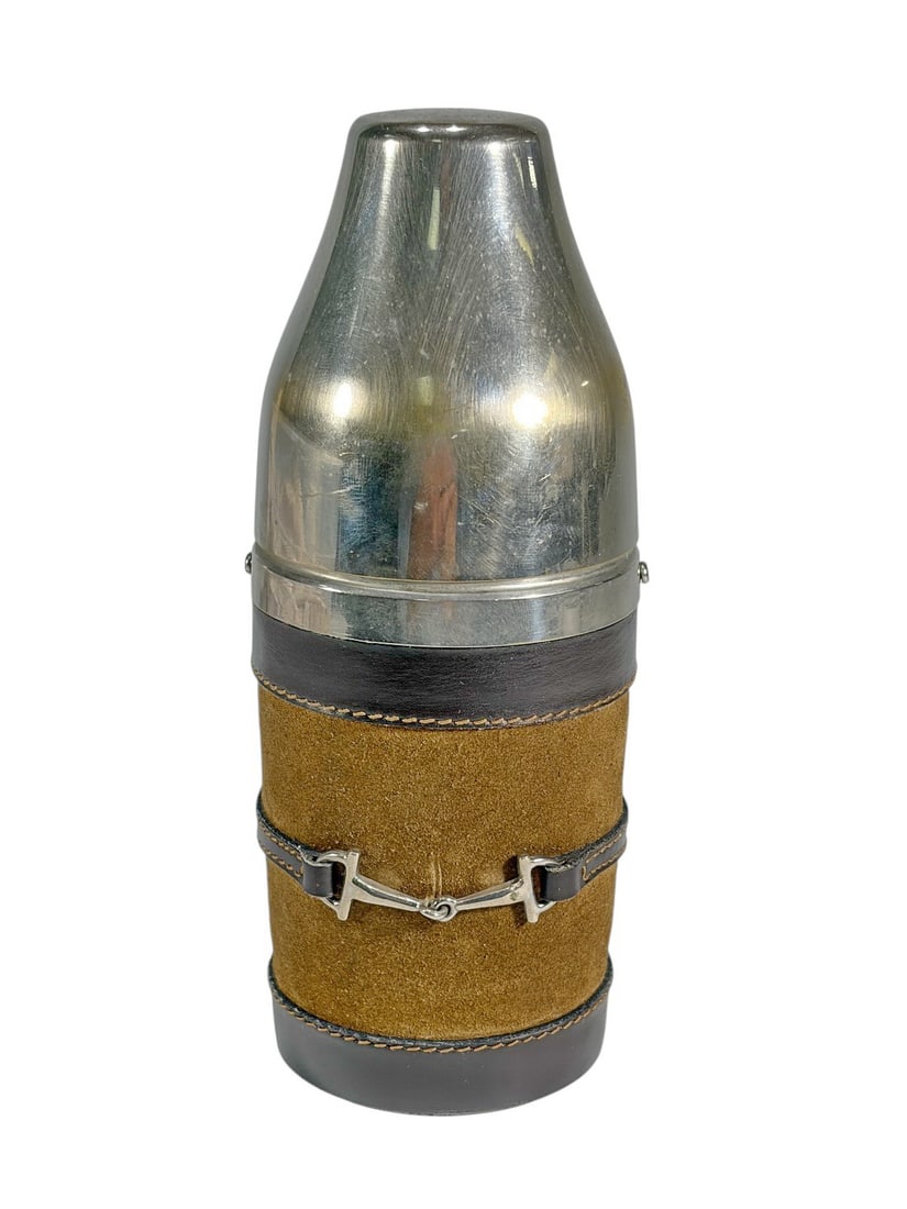 Gucci Italy Leather Wrapped Cocktail Shaker Flask: Gucci cocktail shaker featuring a polished stainless steel body wrapped in brown leather and suede with decorative equestrian horsebit hardware. Marked Gucci Made in Italy on the leather. The shaker i