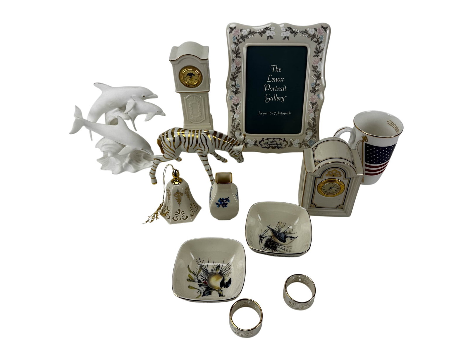 Lenox Porcelain Clock Frame Figurine Mug 12p LOT: Group of twelve Lenox porcelain articles comprising two quartz mantel clocks, Dance of the Dolphins sculpture, Zebra figurine, 25th Anniversary Portrait Gallery 5 x 7 picture frame with box, God Bless