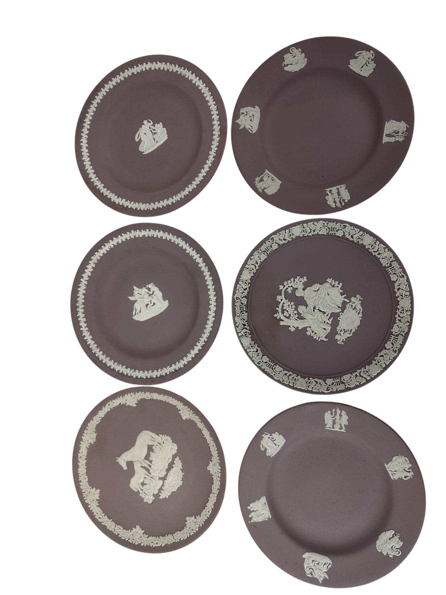 Wedgwood Lilac Jasperware Collector Plates 6pc LOT: Group of six Wedgwood England Lilac Jasperware cabinet plates featuring white applied Neoclassical relief decorations displaying classical mythological figures, cherubs, floral garlands, scrolling bor
