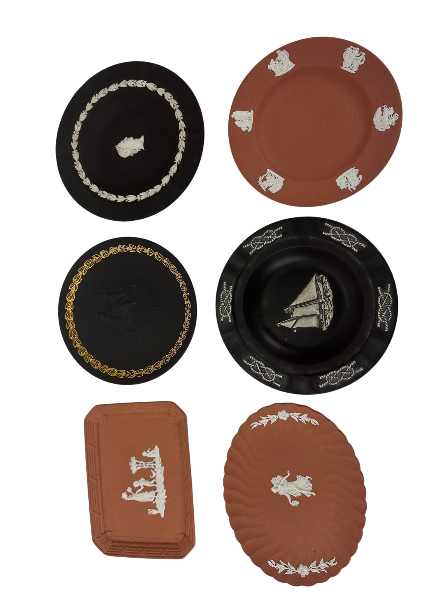 Wedgwood Terracotta & Black Jasperweare Plates LOT: Group of six Wedgwood jasperware display pieces comprising three terracotta and three black examples. The assortment includes round cabinet plates, a rectangular tray, an oval dish, and black basalt p