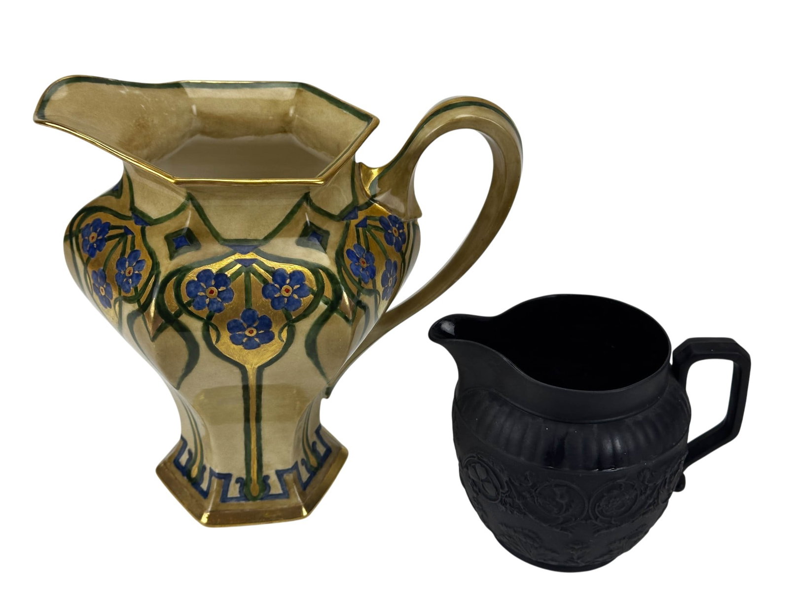 Lenox Art Nouveau & Wedgwood Black Basalt Pitchers: Group of two decorative jugs including a Lenox Art Nouveau porcelain example decorated with hand painted blue blossoms, green foliate motifs, gilt ground panels, geometric border ornamentation, facete
