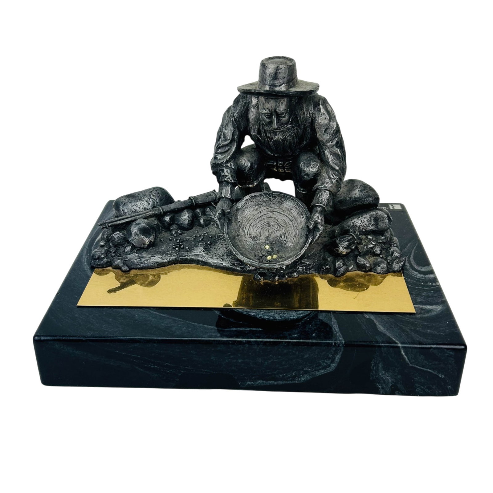 Michael Ricker 1940-2006 Gold Panning LE Sculpture: Michael Ricker (American, 1940-2006) hand crafted pewter sculpture with a strong Western theme subject matter. Depicting a prospector kneeling beside a stream while examining a gold pan with nuggets. 