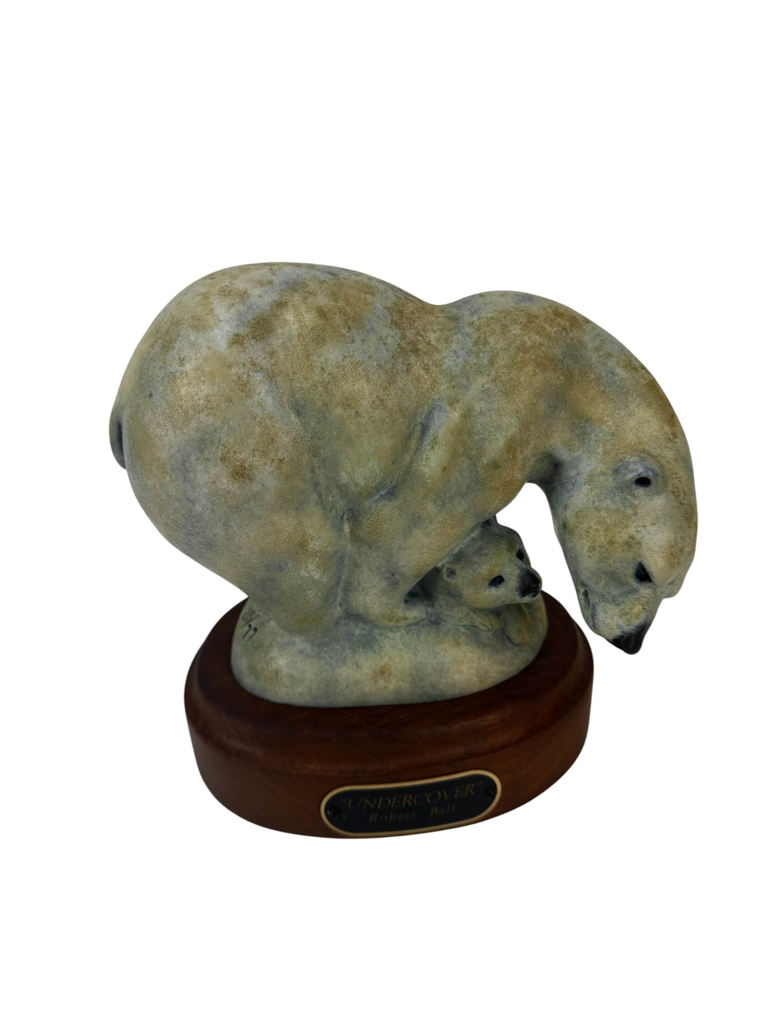 Robert Ball Bronze Undercover Polar Bear Sculpture: Robert Ball (American, 20th Century) nature wildlife sculpture titled "Undercover,". Depicts a polar bear standing protectively over a cub nestled beneath its body. Composition executed in cold-cast b