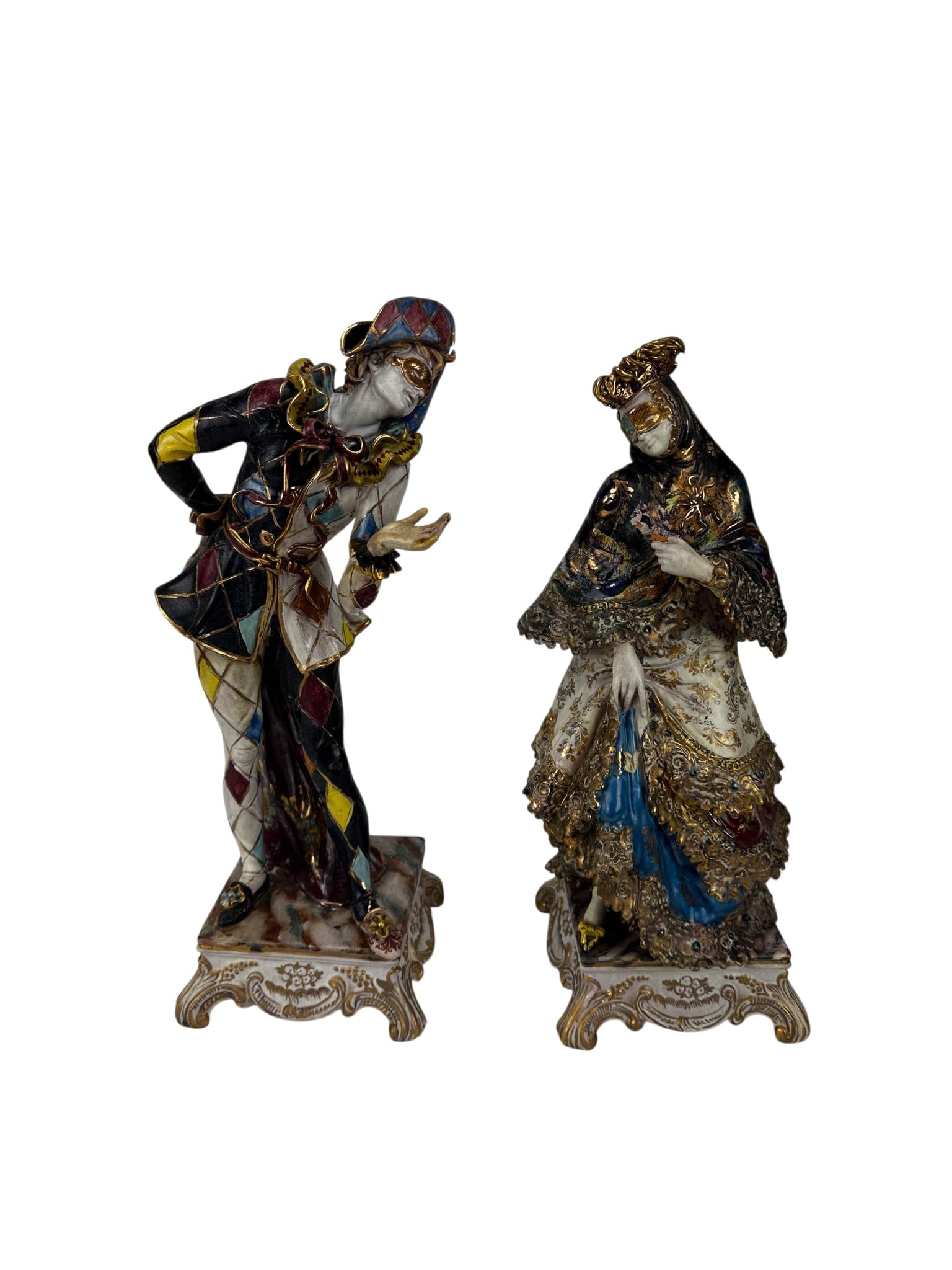 Italian Terracotta Pair Masked Costume Characters: Pair of Italian porcelain figural sculptures depicting Venetian masked costume characters. One portrays a Harlequin in multicolor diamond pattern attire with gilt accents, while the companion depicts 