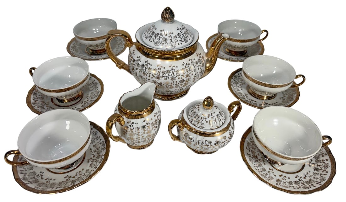 Bavaria Porcelain Tea Service Gold Trim 15pc LOT: Lot of 15 Bavaria porcelain tea service pieces featuring white porcelain with gold floral decoration and gilt trim. Includes one teapot with lid, one covered sugar bowl with lid, one creamer, six teac