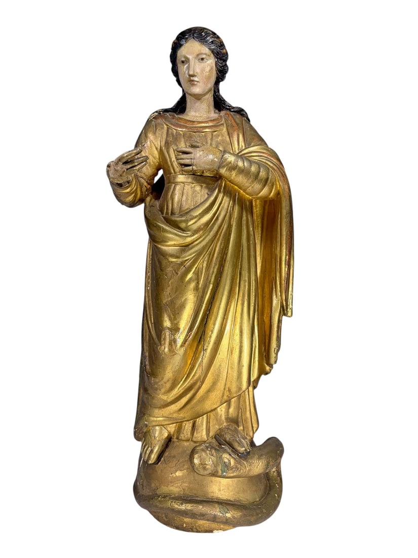 19th C Carved Polychrome Wood Saint Figure Statue: 19th century carved wood religious figure depicting a standing female saint over a serpent. Hand-carved with polychrome and gilt decoration over gesso, exhibiting age-related craquelure and wear throu