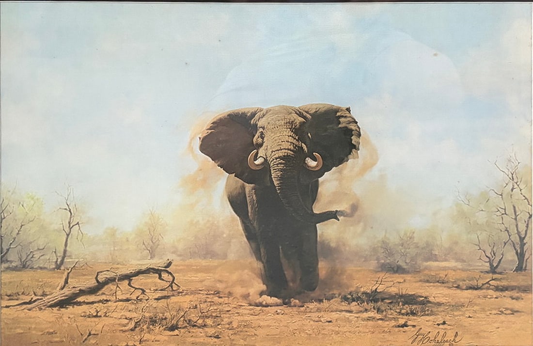 Guy Coheleach "Charging Elephant" Framed Print: Framed wildlife print titled "Charging Elephant" depicting an African elephant in a dramatic landscape. Titled in the mat and bearing the printed signature of Guy Coheleach in the lower right. Present