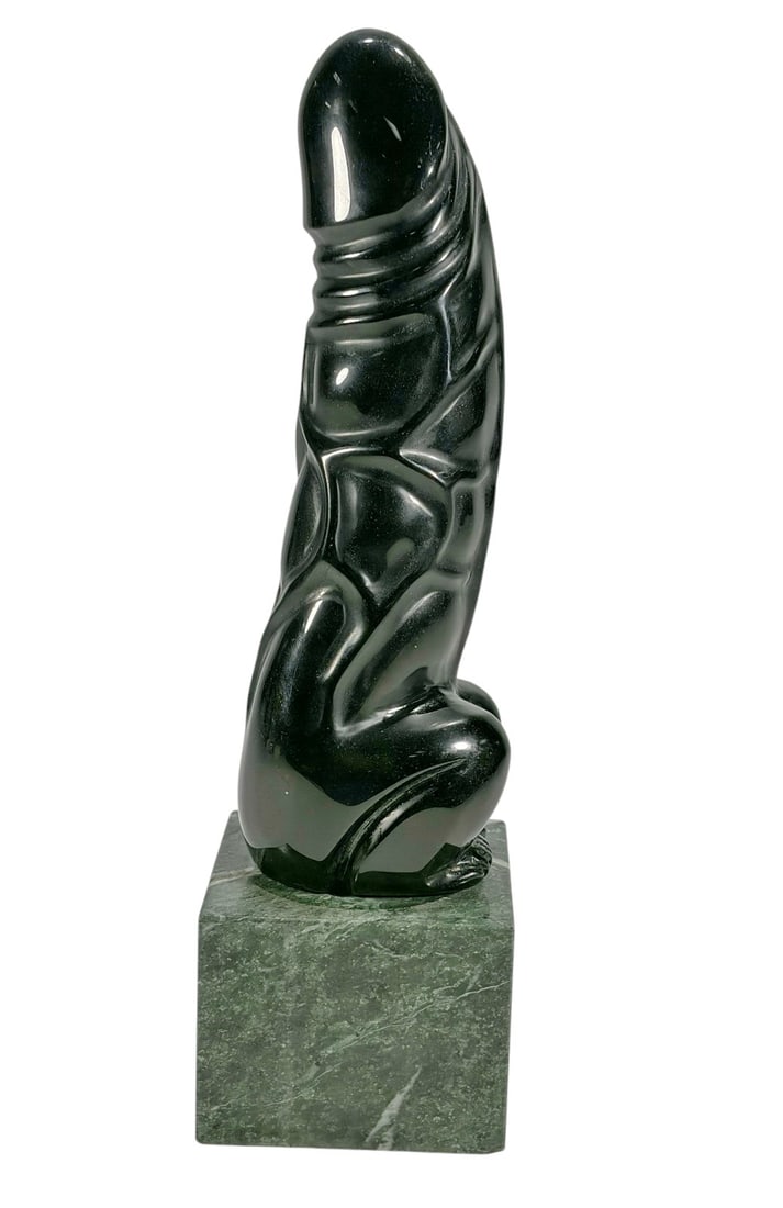 Erotic Black Glass Phallic Sculpture on Marble: Abstract black glass phallic sculpture resting on a green Italian marble base. The sculpture is not permanently attached to the base and simply rests on top. The polished glass sculpture features a st