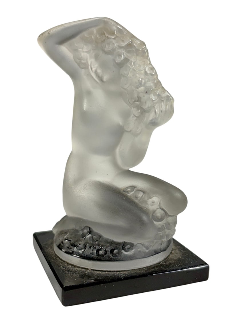 Lalique France Floreal Crystal Figurine Base: Lalique France Floreal frosted crystal figurine depicting a kneeling nude female with flowing floral hair, mounted on a black square base. Signed "Lalique France" on the base Dimensions: 3.25 X 1.75 X