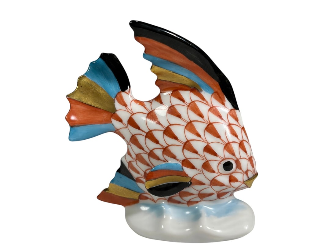 Herend Rust Fishnet Tropical Fish Porcelain Figure: Herend Hungary hand-painted porcelain tropical fish figure in the rust fishnet pattern with multicolor fins and gilt accents, mounted on a stylized wave base. Marked Herend Hungary Handpainted on the 