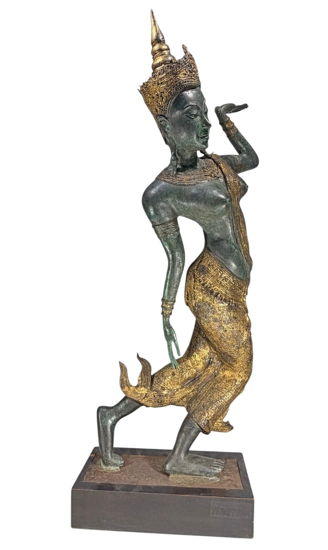 Thai Bronze Dancer Sculpture Wanissian Base: Thai-style bronze sculpture depicting a traditional dancer in an elegant pose with one arm raised, wearing an ornate tiered headdress, elaborate jewelry, and richly decorated garments. The bronze reta