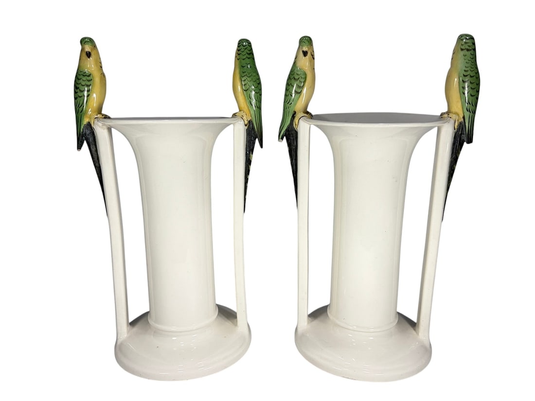 Pair of Art Deco Czechoslovakian Porcelain Vases: Pair of Art Deco porcelain bud vases made in Czechoslovakia. Each vase features two hand-painted green and yellow parrots perched on opposing sides of the rim, supported by slender vertical struts ris