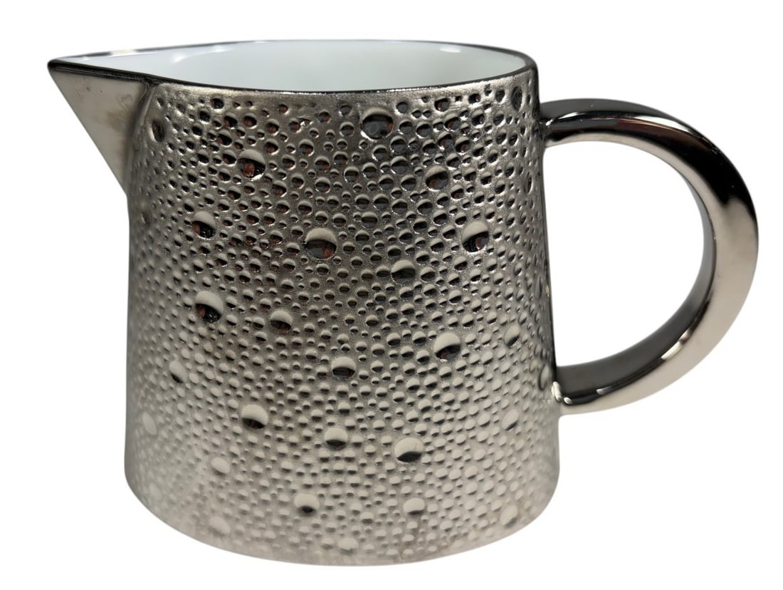 Bernardaud Ecume Platine Creamer France: Bernardaud "Ecume Platine" creamer, Limoges porcelain, France. Featuring the collection's signature textured platinum finish inspired by sea foam, with a sculptural platinum handle and pouring spout. 