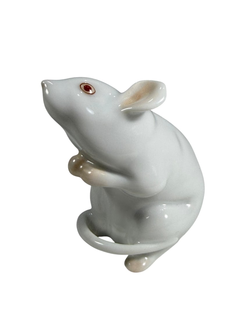 Herend Hungary Miniature Mouse Porcelain Figure: Herend Hungary hand-painted miniature porcelain mouse figurine depicted seated with its front paws raised and tail curled around its body. Decorated in the classic white glaze with pink ears, feet, an