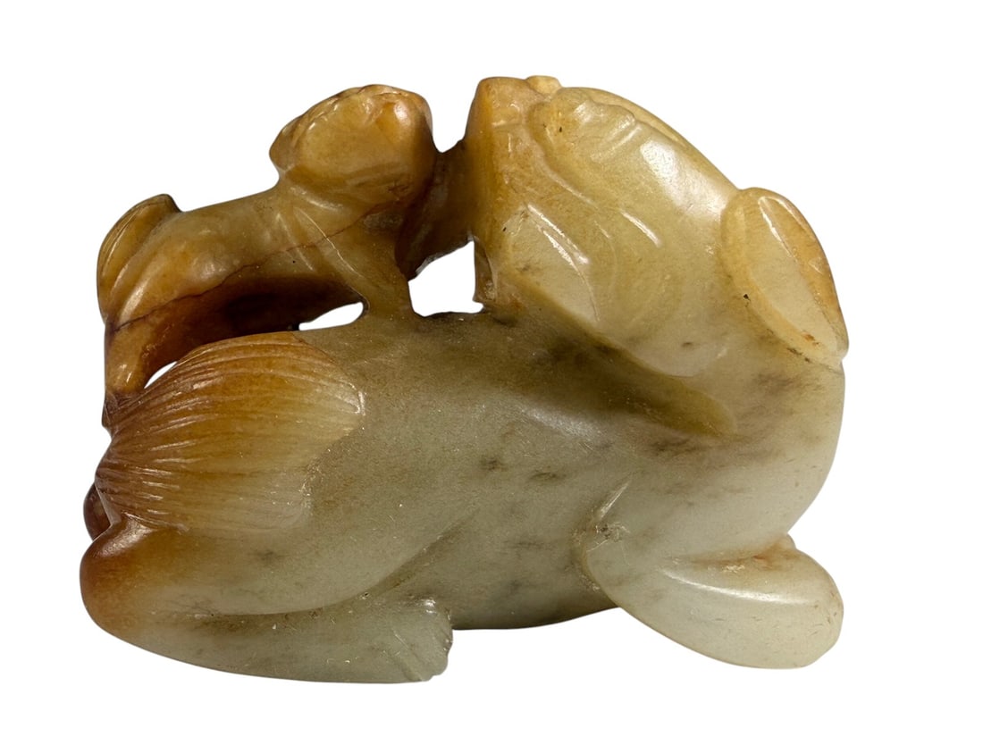 Chinese Celadon Jade Lion & Vase Carving Figure: Chinese celadon jade carving depicting a guardian lion beside a covered ritual vase. Carved from a single piece of jade with natural russet inclusions that enhance the sculptural details. Weight: 73 g