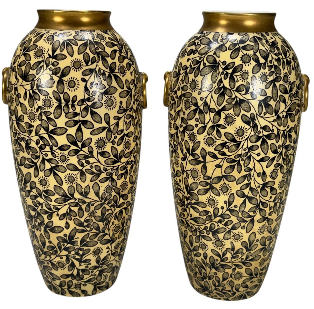 Pair of Royal Rudolstadt Porcelain Vases: Lot of two Royal Rudolstadt porcelain vases in the English Aesthetic Movement taste. Each features an elongated baluster form with gilt rims and applied ring handles, decorated with an allover stylize