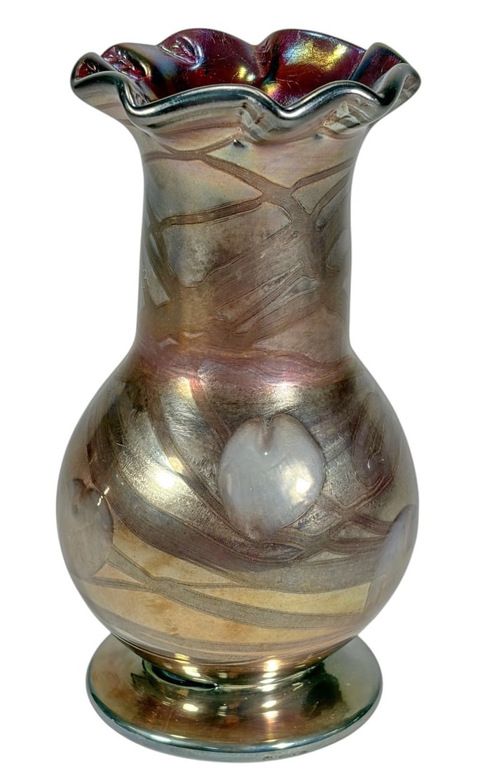 Art Nouveau Iridescent Tulip Relief Glass Vase: Art Nouveau iridescent art glass vase featuring a flared, ruffled rim and a bulbous body with an elongated neck. Decorated with raised white tulip blossoms in relief over a luminous gold and bronze ir