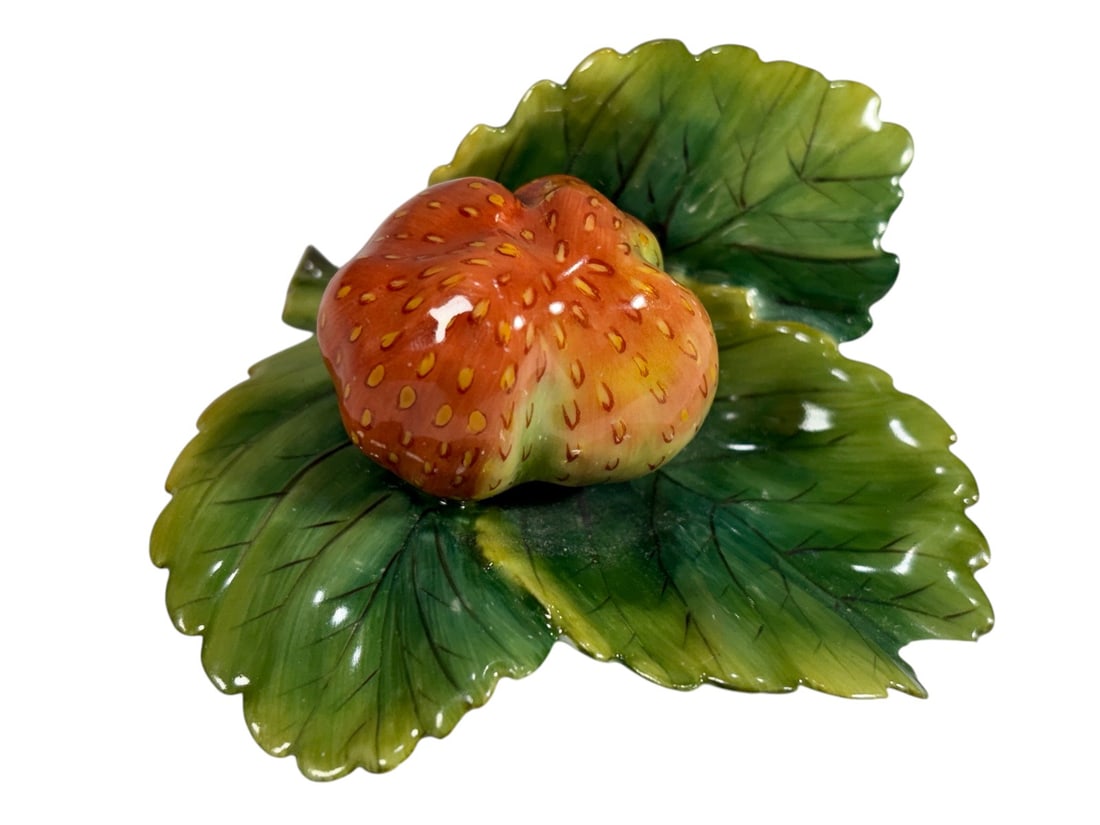 Herend Hungary Hand Painted Porcelain Fruit Figure: Herend Hungary hand-painted porcelain fruit figurine with shaded orange glaze and green leaves, modeled in a naturalistic form. Underside bears the Herend Hungary hand-painted backstamp. Dimensions: 1
