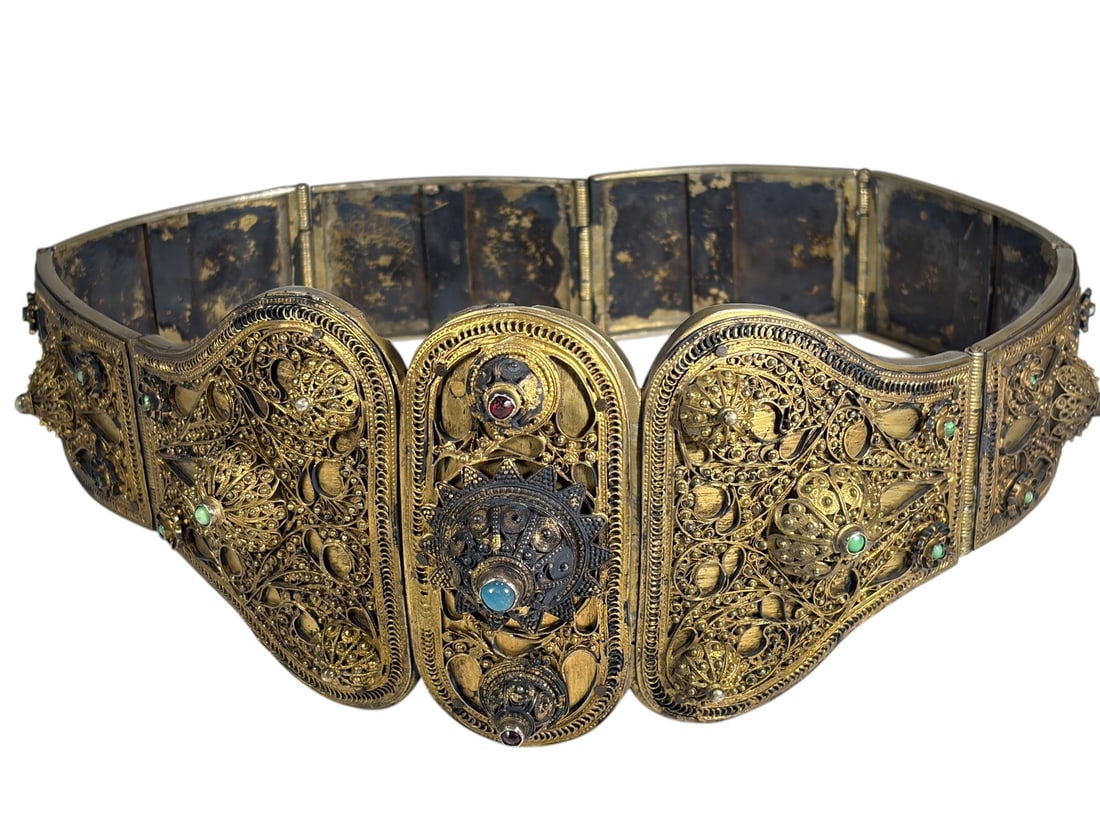 19th C. Caucasian Silver Filigree Belt Gilt Tone: Late 19th century Caucasian silver filigree belt composed of articulated panels with intricate openwork decoration. The central clasp is accented with turquoise-colored and red stones, while the remai