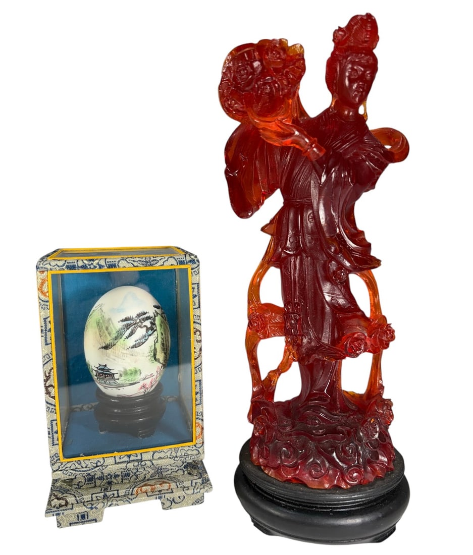 Chinese Egg & Quan Yin Resin Figure 2pc LOT: Lot of two Asian decorative collectibles. Includes one hand-painted Chinese egg depicting a traditional mountain landscape, housed in a glass display case with a fabric-covered frame and wooden base. 