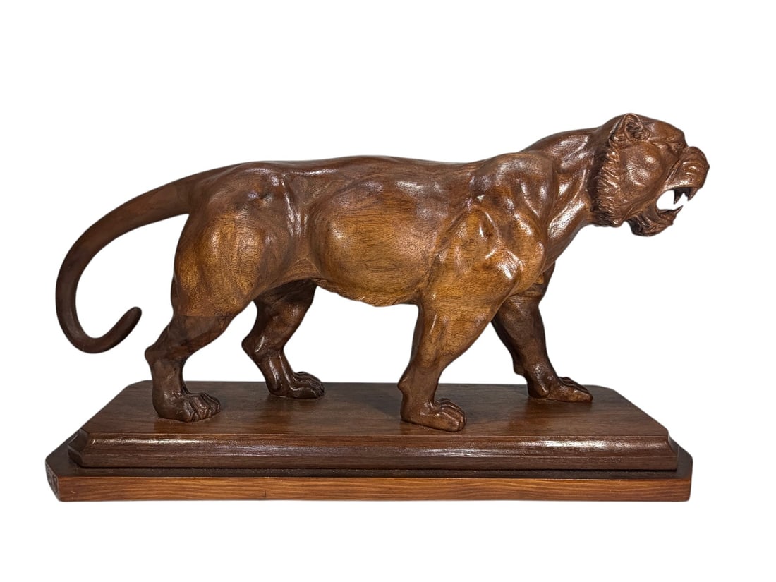 Carved Wood Tiger Sculpture on Stand Decorative: Carved wood sculpture depicting a roaring tiger or panther in a dynamic standing pose, mounted on a fitted wood display base. The carving features finely modeled musculature and expressive facial deta