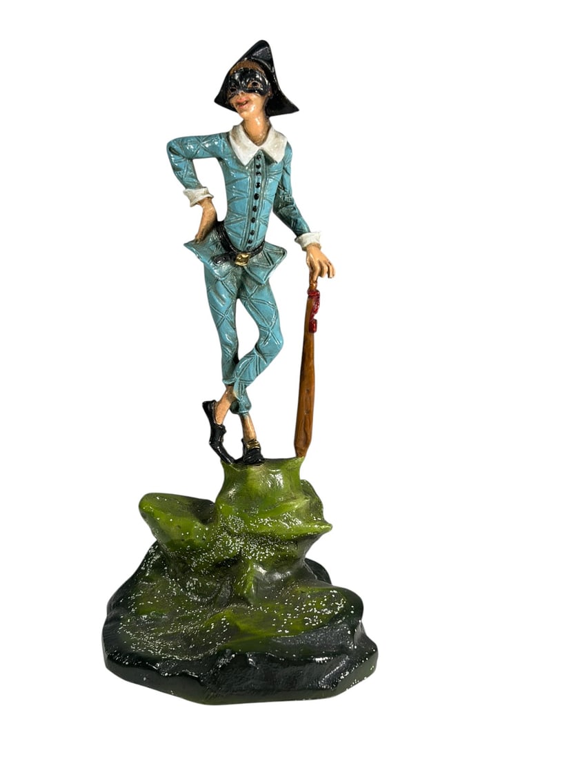 Austrian Style Harlequin Figurine Painted Figure: Austrian style painted figurine depicting Harlequin (Arlecchino), the masked character from the Commedia dell'Arte. The figure is shown in a lively pose wearing a blue costume and black mask while hol