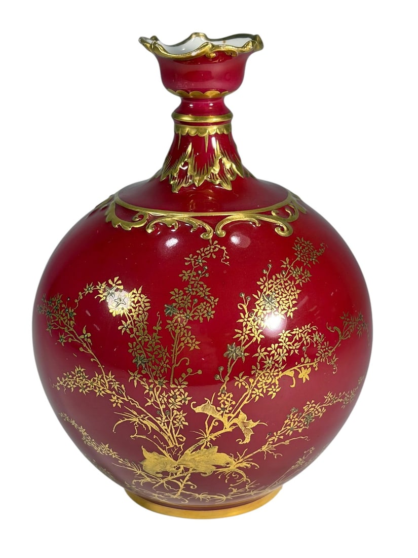 Royal Crown Derby Red Gilt Porcelain Bottle Vase: Royal Crown Derby porcelain bottle vase in a rich oxblood red glaze with gilt decoration depicting flowering branches and birds. Features an elegant bulbous body with a flared, scalloped rim and hand-