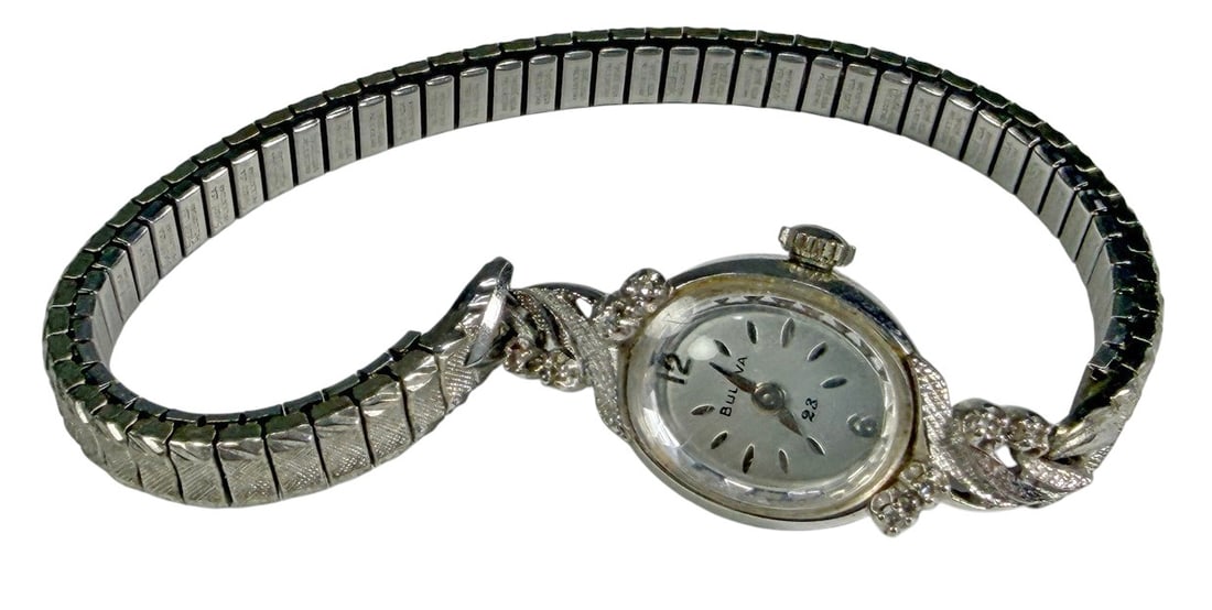 Bulova 14K Gold Ladies Wristwatch 1974 Award Watch: Vintage Bulova ladies wristwatch featuring a 14K gold case and silver-tone dial with applied hour markers and black hands. The case back is engraved: "Mary M. Canter, 20 Years Service, The Wadsworth E