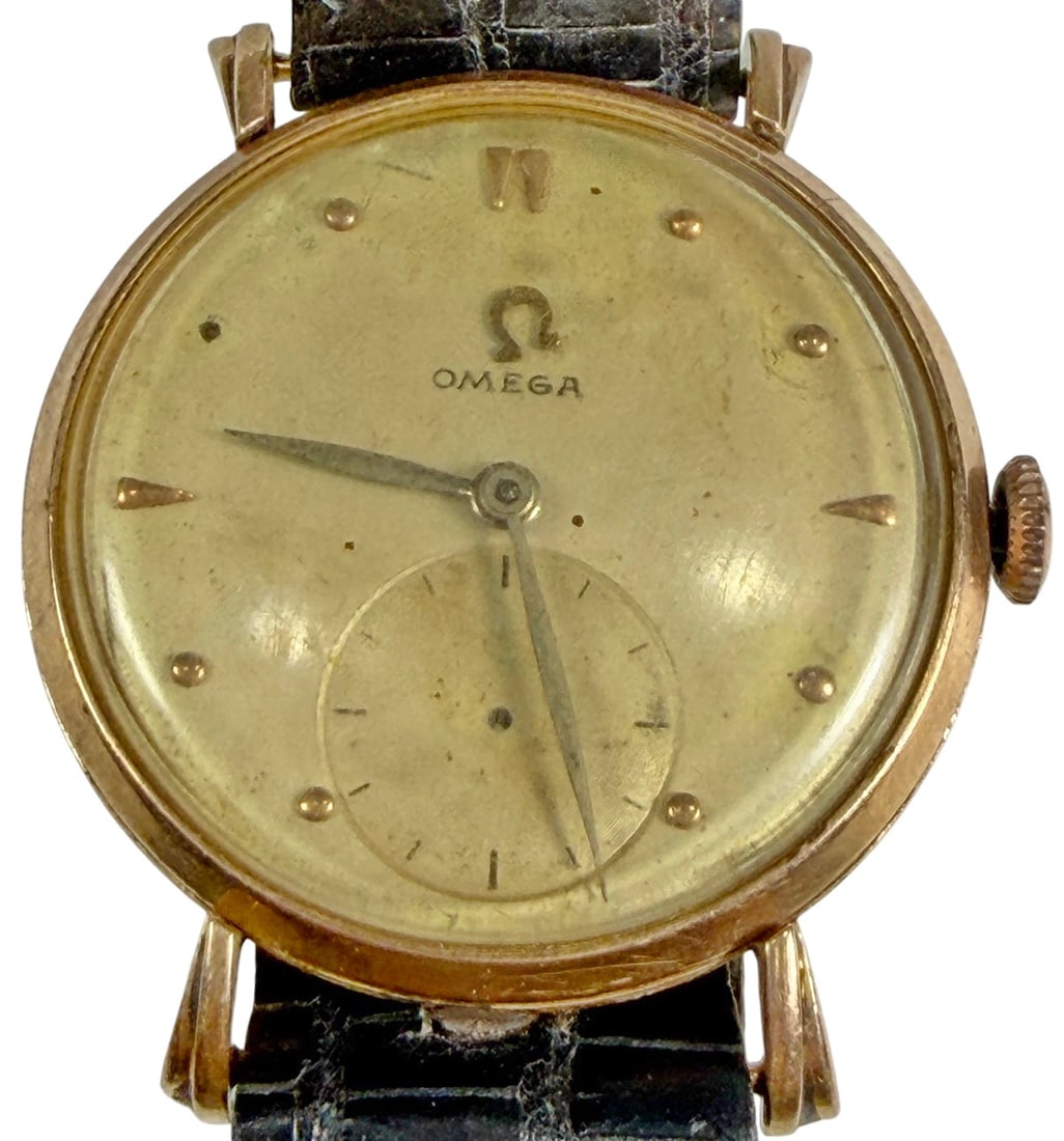 Omega 18K Gold Manual Wind Wristwatch Leather Band: Vintage Omega manual wind wristwatch with an 18K gold case and gold-tone dial featuring applied hour markers, dauphine hands, and a subsidiary seconds register. The case back is hallmarked "18K 0.750.