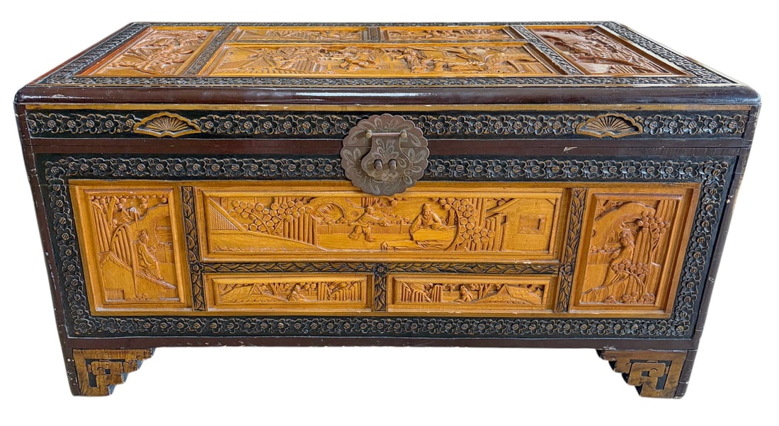 Chinese Carved Camphor Wood Blanket Chest Trunk: Chinese camphor wood blanket chest, fully hand carved with figural, landscape, and village scenes on the lid, front, back, and sides. Features ornate brass lock hardware and a spacious interior.