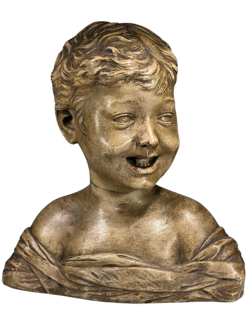 Terracotta Bust of Smiling Child Sculpture: Terracotta bust depicting a smiling young child with finely modeled facial features, flowing hair, and draped garment. Finished with a warm brown patina accentuating the sculptural details.
