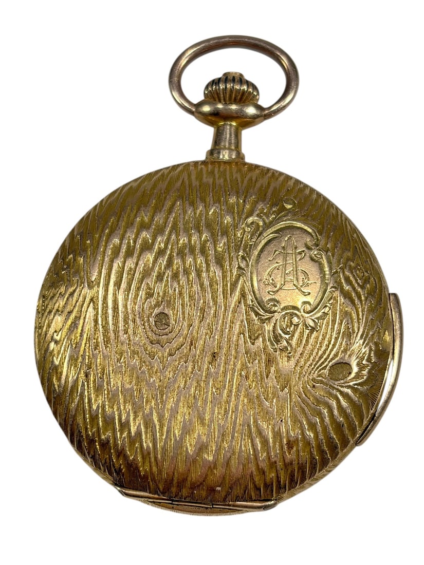 French 18K Gold Hunter Case Pocket Watch Swiss: French 18K gold hunter case pocket watch with an engraved woodgrain-style case and monogram cartouche to the front cover. White enamel dial with Arabic numerals and subsidiary seconds register. Swiss