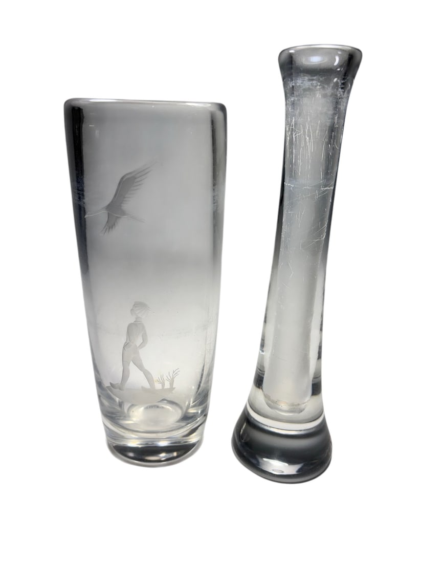 Orrefors Crystal Vase & Etched Glass Vase 2pc LOT: Two-piece art glass lot including an Orrefors crystal bud vase, acid-etched and signed on the underside, together with a cylindrical etched glass vase decorated with a stylized figure and bird motif. 
